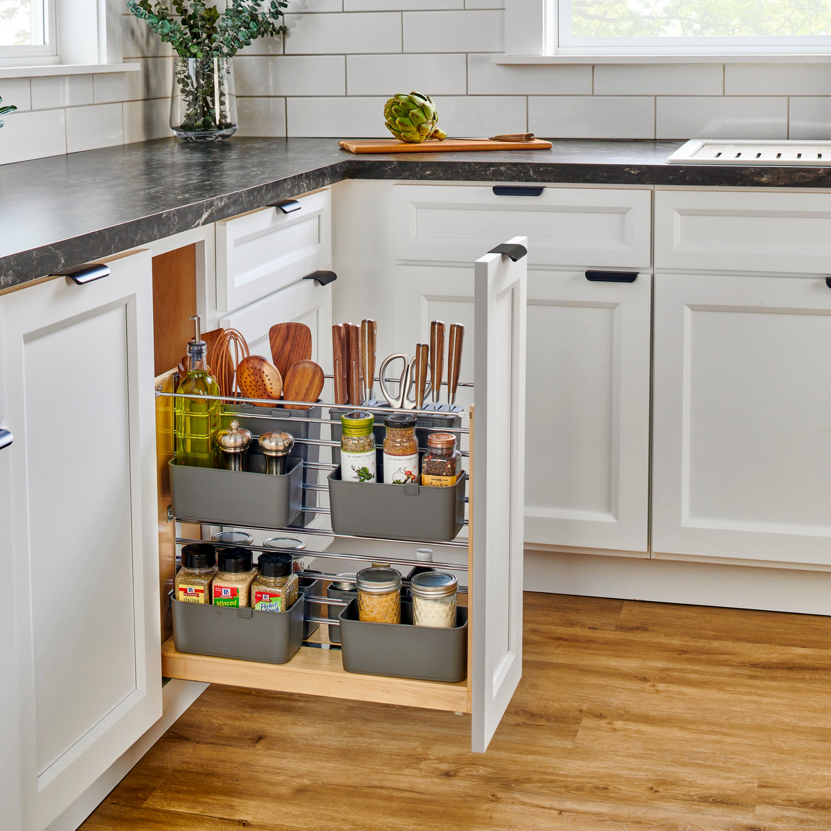 White cabinet open with a sliding drawer with multiple levels of storage racks.