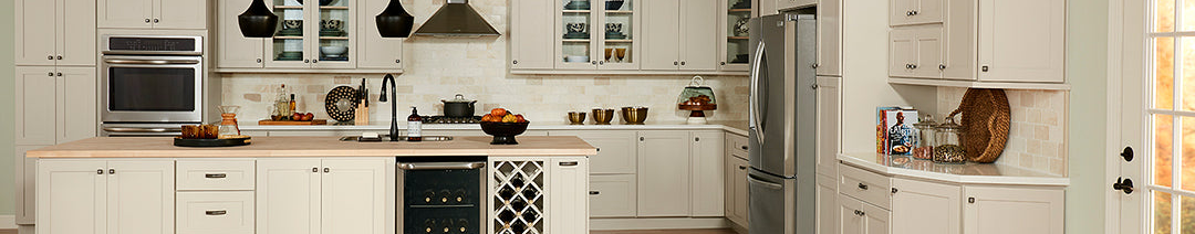 Image of Nantucket Bluff kitchen cabinets along with white hood and a wooden island with marble countertops