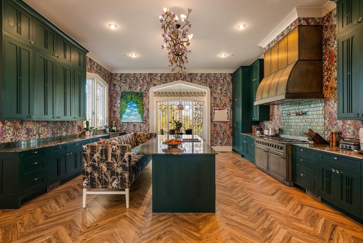 Image of kitchen with dark green Gracious Home Custom cabinets wooden floors and floral wallpaper